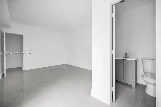 a white toilet sitting next to a bathroom sink