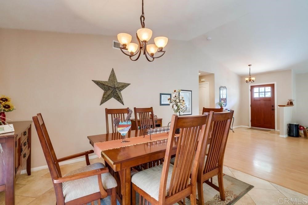 16651 Airmail Lane Ramona, CA 92065 - Photo 11 of 36 a dining room with furniture a chandelier and wooden floor
