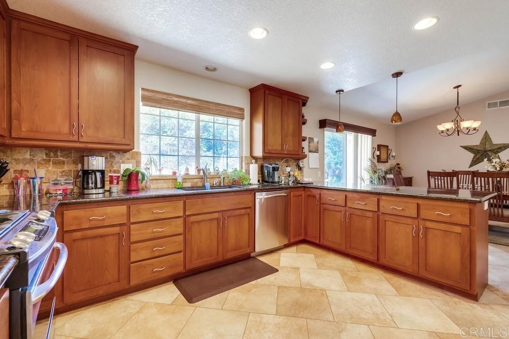 16651 Airmail Lane Ramona, CA 92065 - Photo 13 of 36 a kitchen with stainless steel appliances granite countertop a sink and cabinets