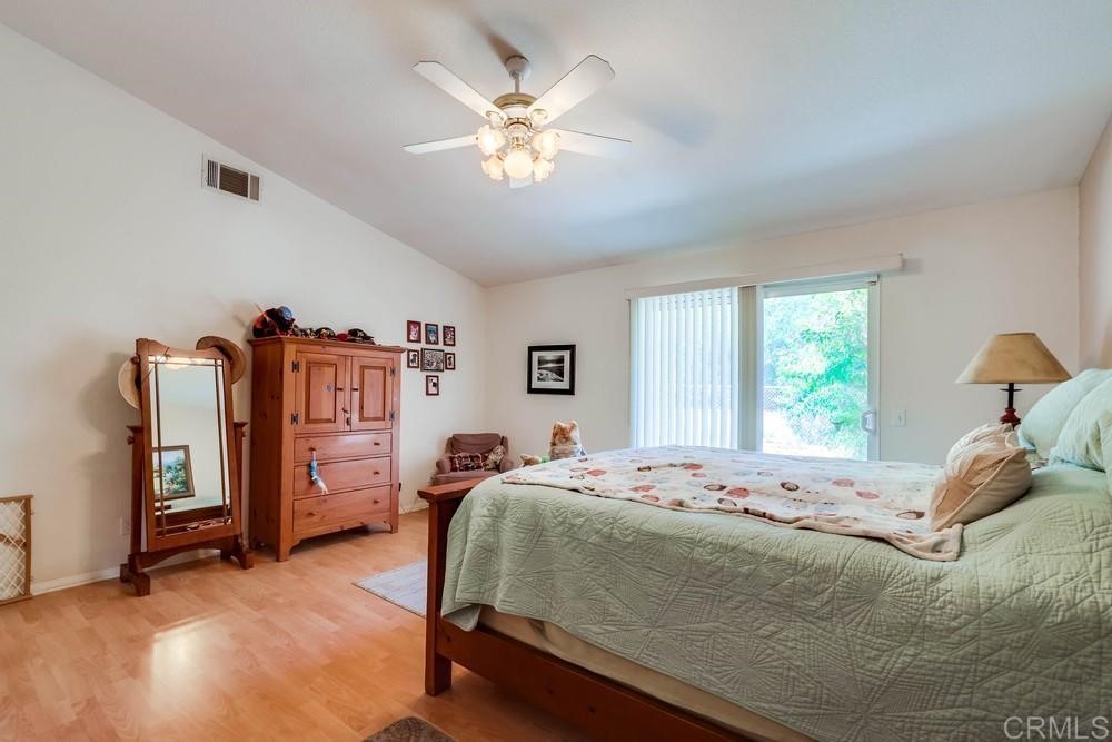 16651 Airmail Lane Ramona, CA 92065 - Photo 17 of 36 a bedroom with a bed and a chandelier