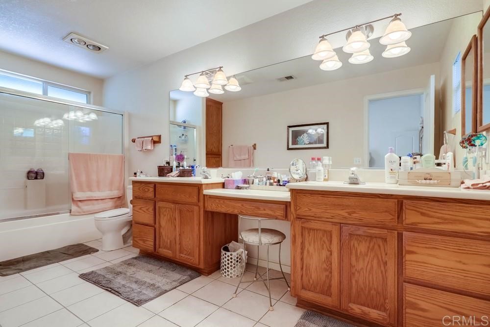 16651 Airmail Lane Ramona, CA 92065 - Photo 18 of 36 a bathroom with a sink vanity tub and shower
