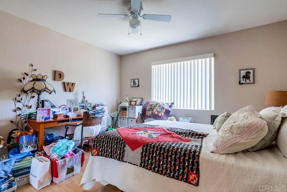 16651 Airmail Lane Ramona, CA 92065 - Photo 21 of 36 a bedroom with bed and a chandelier