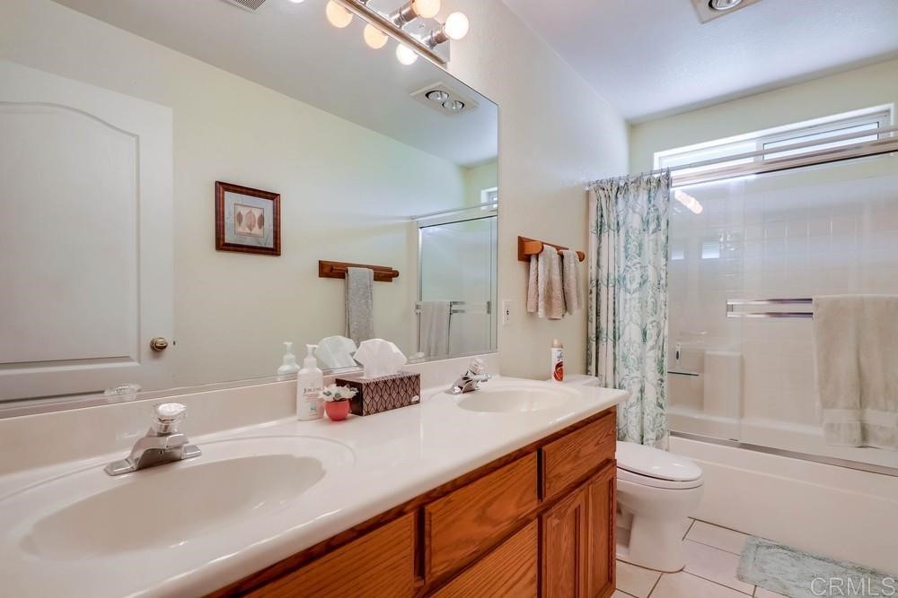 16651 Airmail Lane Ramona, CA 92065 - Photo 22 of 36 a bathroom with a sink a toilet and shower