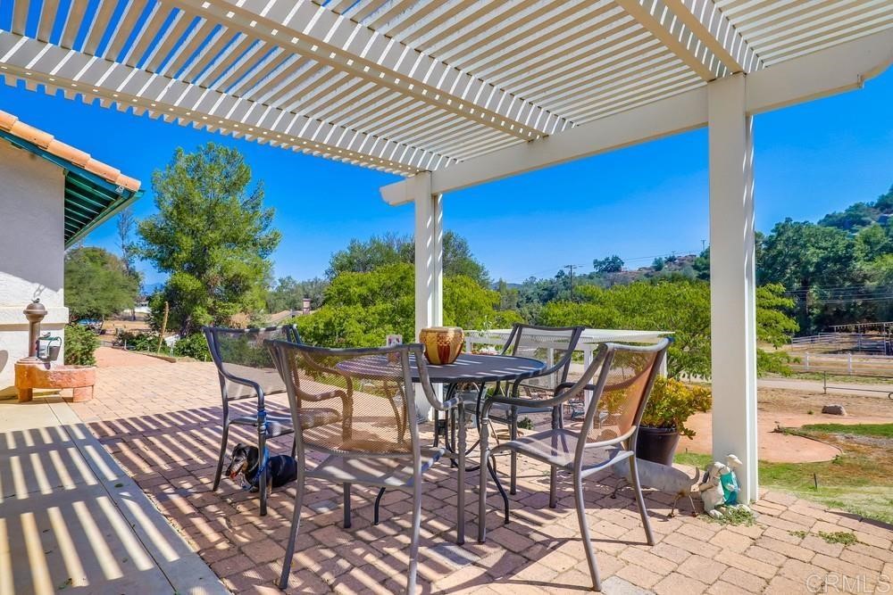 16651 Airmail Lane Ramona, CA 92065 - Photo 24 of 36 a patio with table and chairs and potted plants
