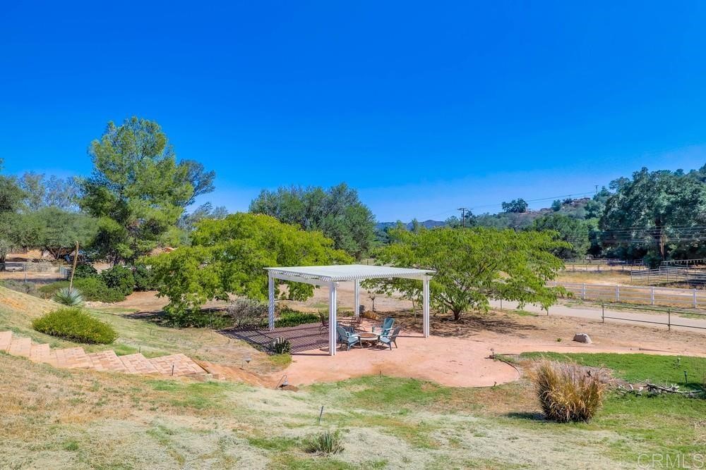 16651 Airmail Lane Ramona, CA 92065 - Photo 28 of 36 a view of a swimming pool with lawn chairs under an umbrella