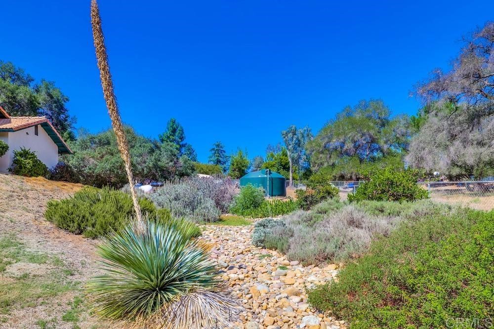 16651 Airmail Lane Ramona, CA 92065 - Photo 30 of 36 a view of a garden with a building in front of it