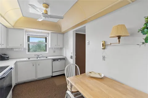 a view of a dining room with furniture and window
