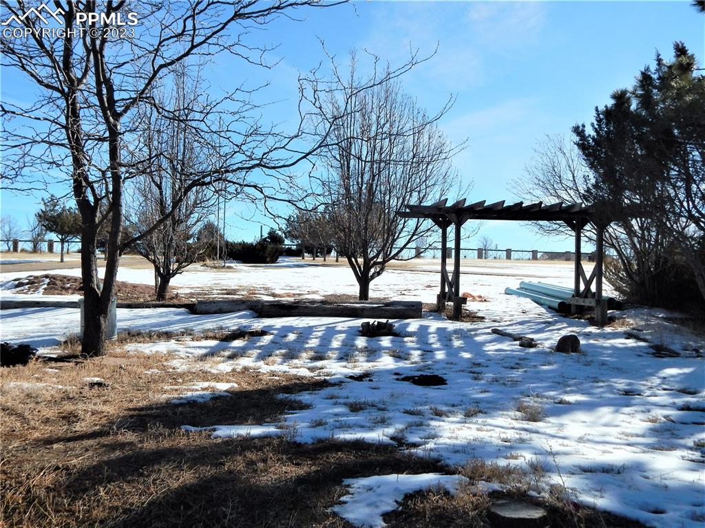 3220 Hoofprint Road Peyton, CO 80831 - Photo 16 of 22 a view of a yard with snow on the road
