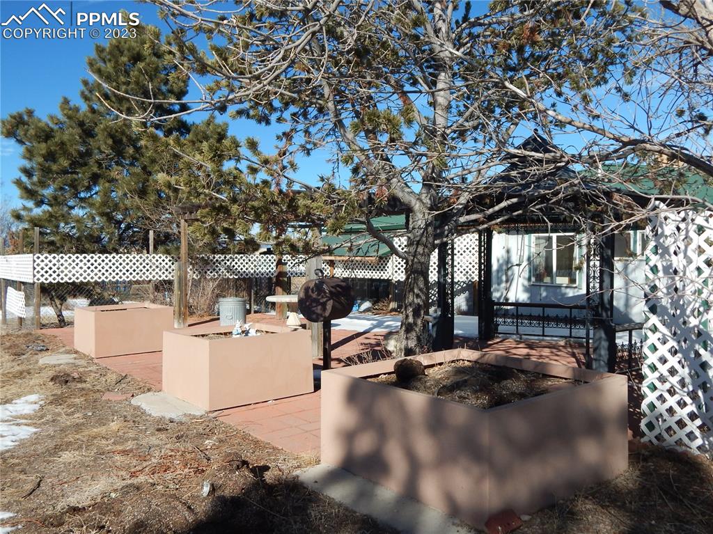 3220 Hoofprint Road Peyton, CO 80831 - Photo 18 of 22 a view of a patio with table and chairs under an umbrella