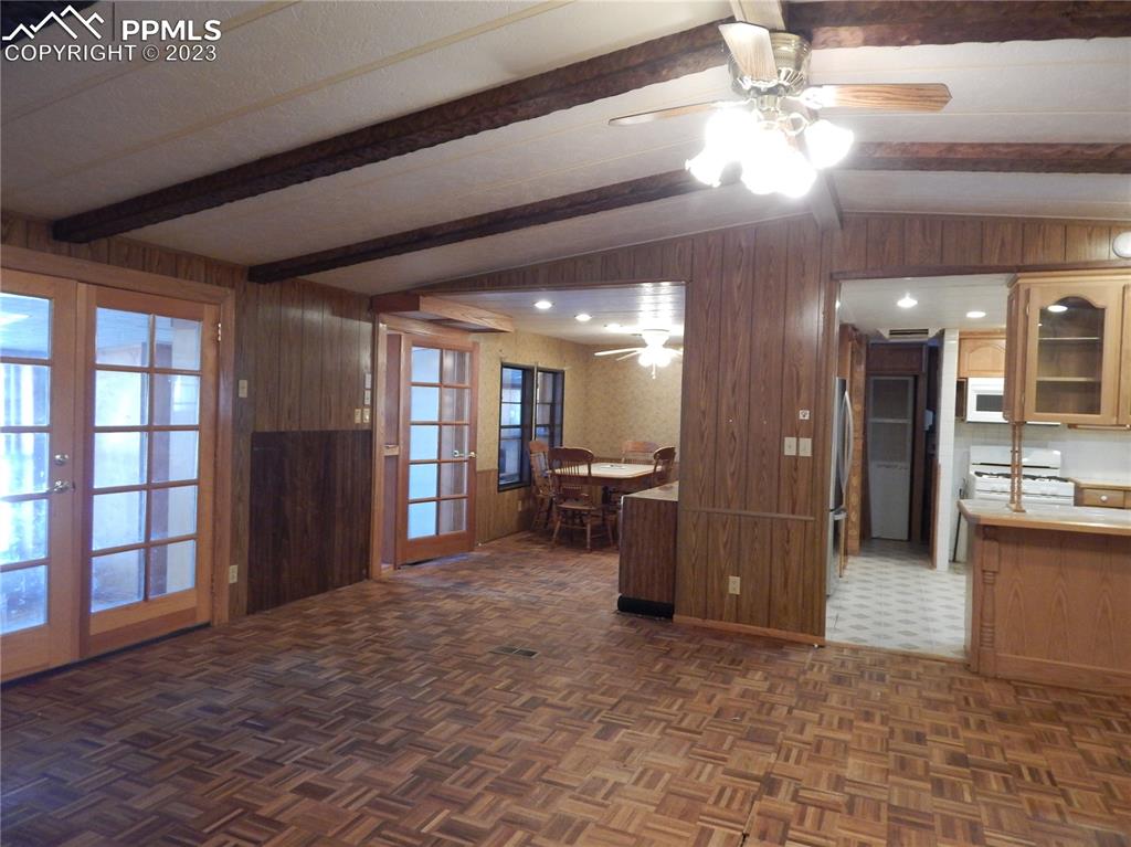 3220 Hoofprint Road Peyton, CO 80831 - Photo 2 of 22 a view of a hallway with dining area and chandelier