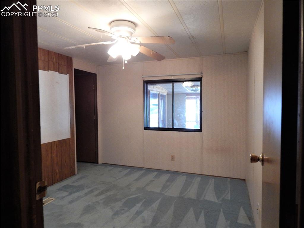3220 Hoofprint Road Peyton, CO 80831 - Photo 9 of 22 wooden floor in an empty room with a window