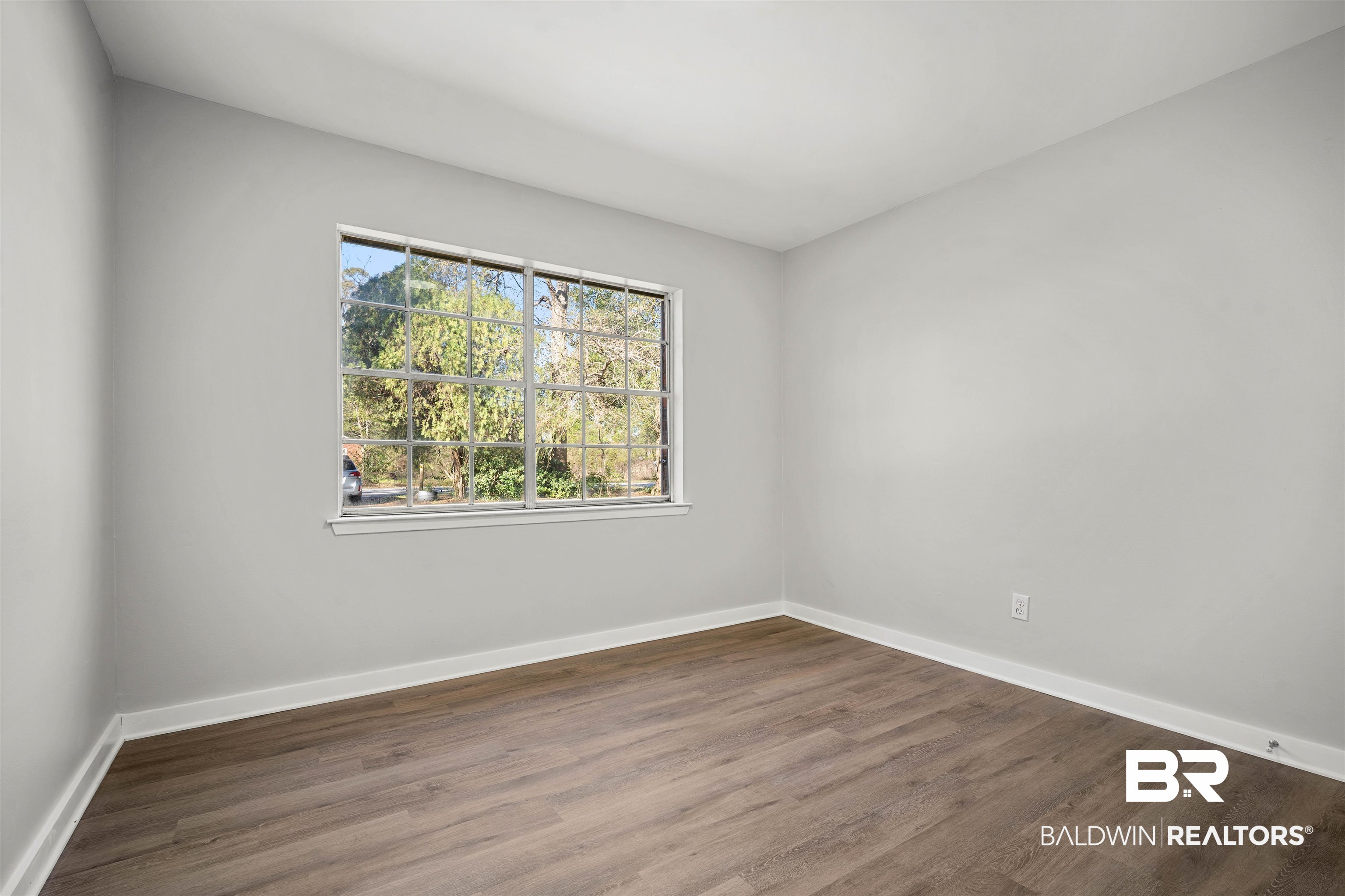 1368 Hubert Pierce Road Mobile, AL 36608 - Photo 19 of 25 Empty room featuring baseboards and dark wood-type flooring