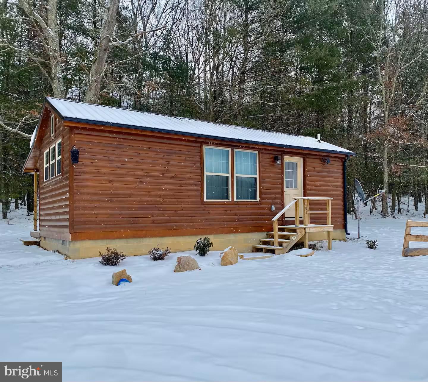 184 Skiles- Pitsenbarger Road Franklin, WV 26807 - Photo 4 of 39 Charming cabin nestled in winter's embrace.