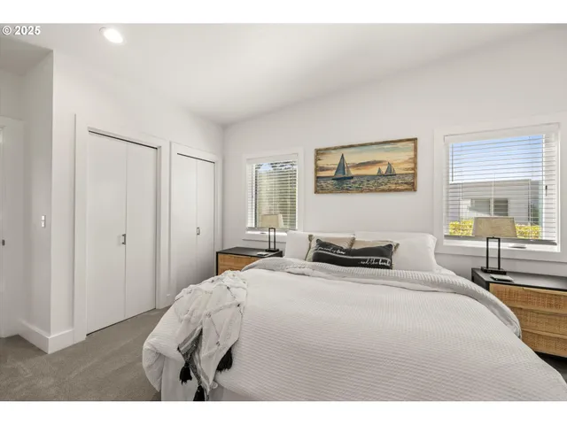 a bedroom with a bed and a painting on the wall