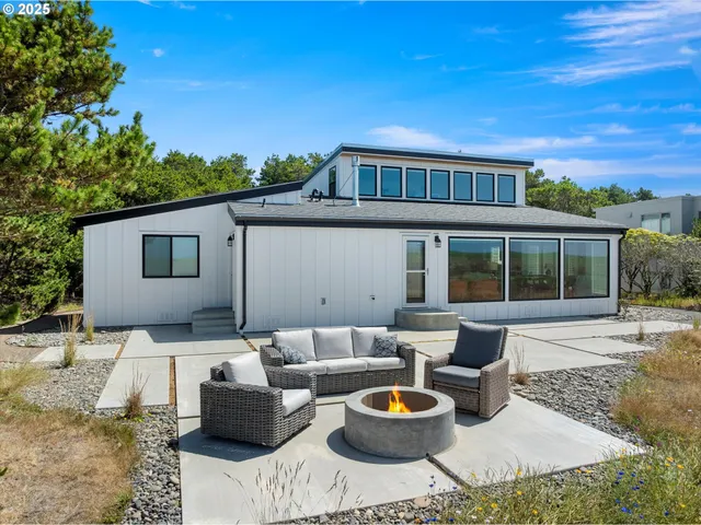 a view of a patio with couches and table and chairs and potted plants