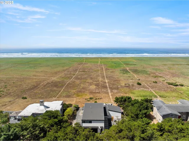 an aerial view of ocean with residential house
