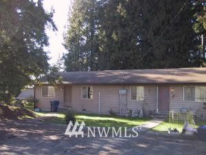 122 West Winesap Road Bothell, WA 98012 - Photo 1 of 1 a view of a brick house with a large window and large tree
