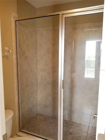 a bathroom with a glass shower door
