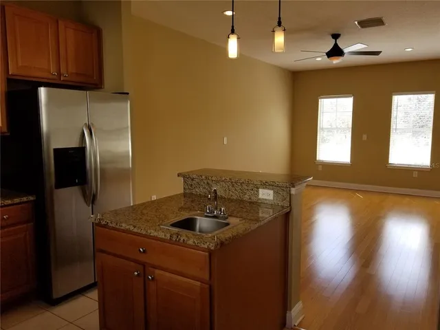 a kitchen with a sink a refrigerator and window