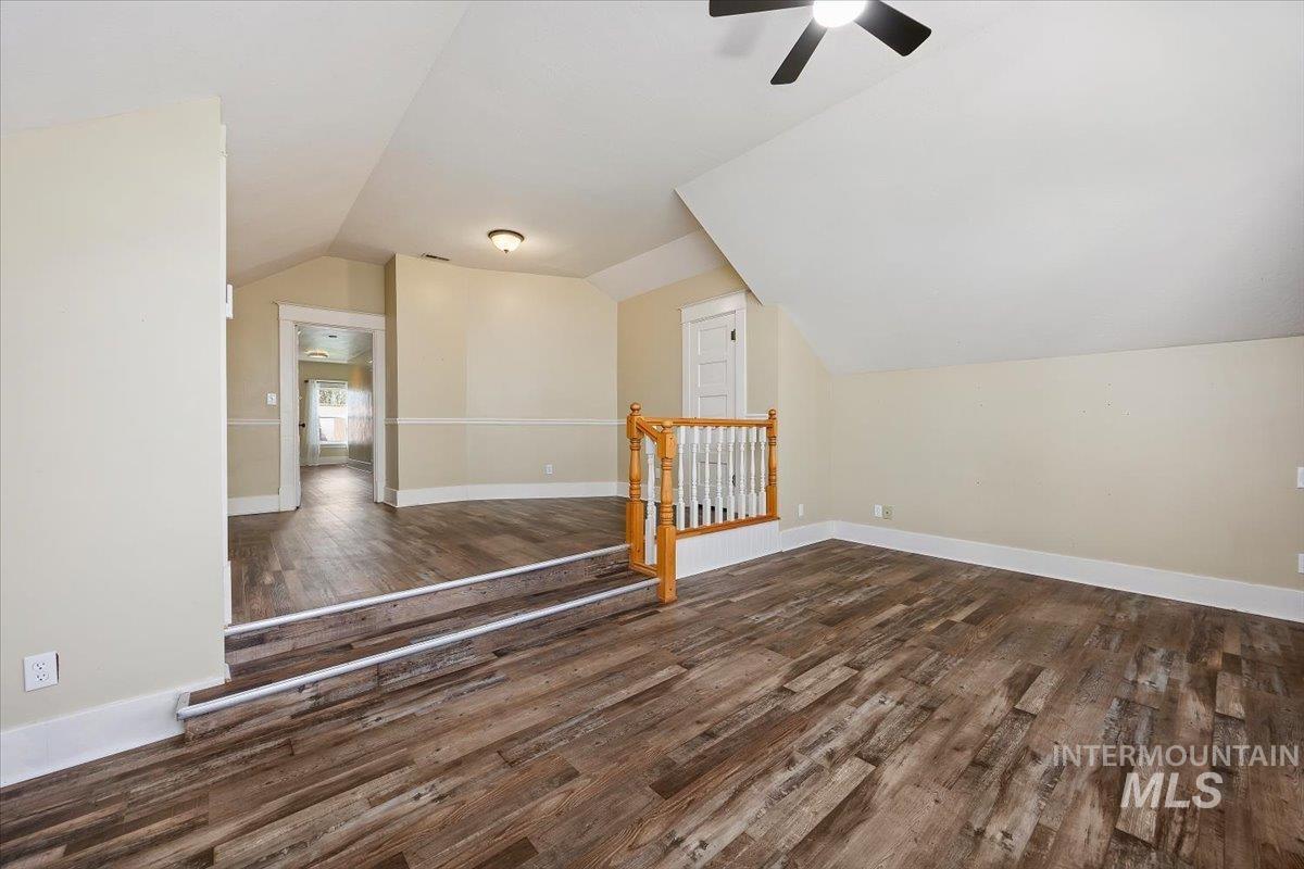 813 7th Street Rupert, ID 83350 - Photo 32 of 48 Spacious room featuring wood-finish flooring, a contemporary ceiling fan, and a built-in railing with white spindles