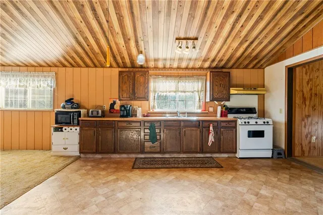 a kitchen with a stove a sink and a refrigerator