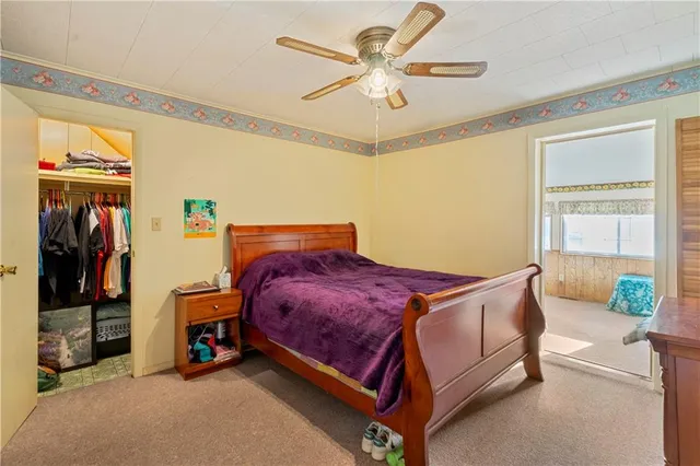 a bed sitting in a room next to a window