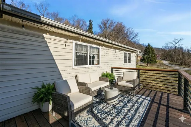 a view of a patio with chairs and potted plants