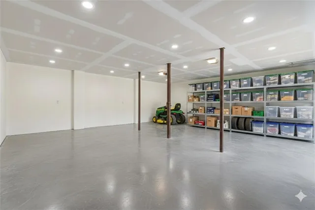 a view of a room with gym equipment and a ceiling fan