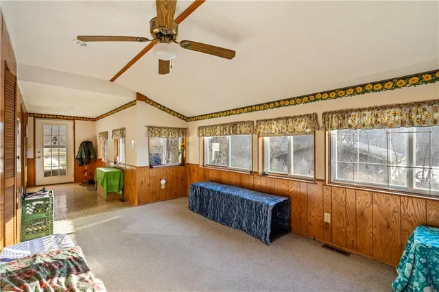 a bedroom with furniture and large windows