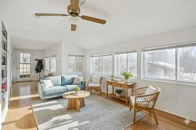a living room with furniture a table and a potted plant