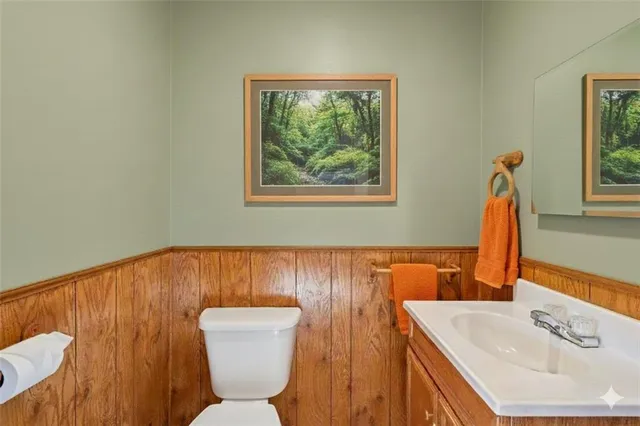 a bathroom with a sink a toilet and mirror