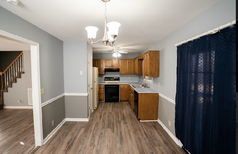 5026 Mt Zion Road Springfield, TN 37172 - Photo 7 of 18 a kitchen with kitchen island granite countertop wooden floors stainless steel appliances a sink and a refrigerator