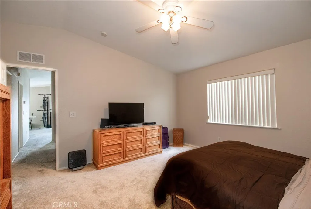 14352 Beach Westminster Ca, Unit 67 Westminster, CA 92683 - Photo 11 of 16 a bedroom with a bed and a flat tv screen on dresser