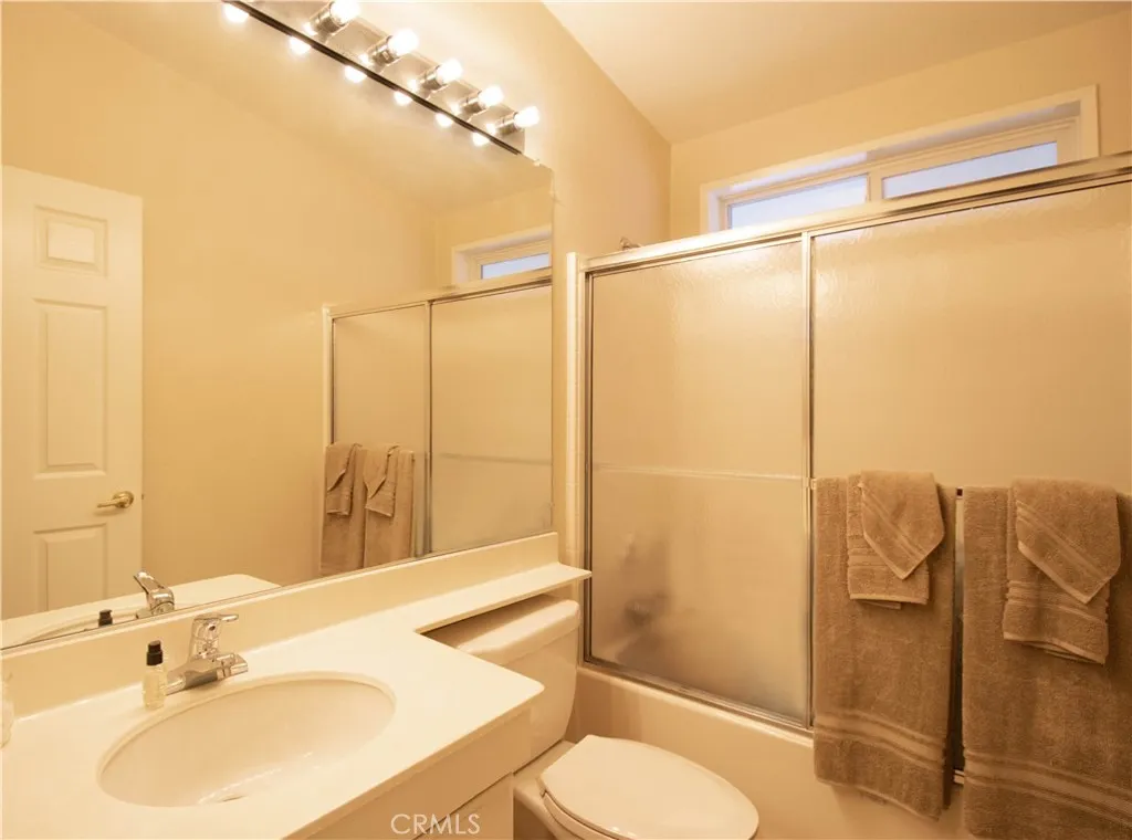 14352 Beach Westminster Ca, Unit 67 Westminster, CA 92683 - Photo 15 of 16 a bathroom with a sink vanity mirror and toilet