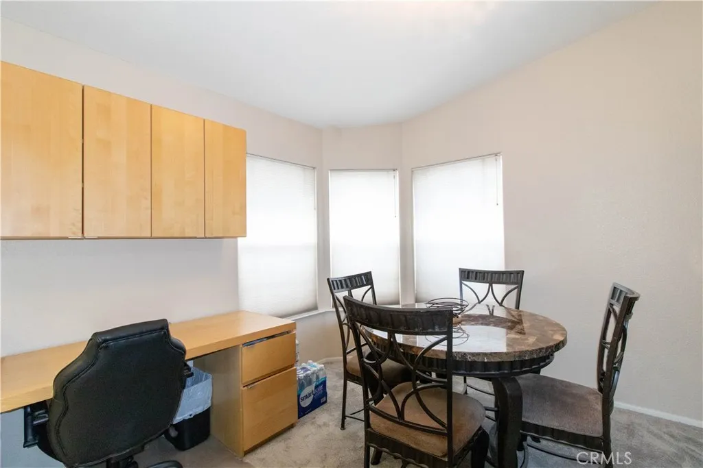 14352 Beach Westminster Ca, Unit 67 Westminster, CA 92683 - Photo 3 of 16 a view of a dining room with furniture and a window