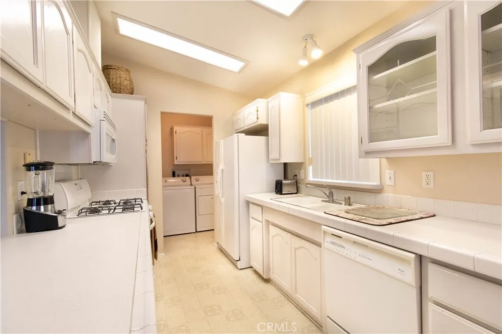 14352 Beach Westminster Ca, Unit 67 Westminster, CA 92683 - Photo 4 of 16 a kitchen with a stove a sink and a refrigerator
