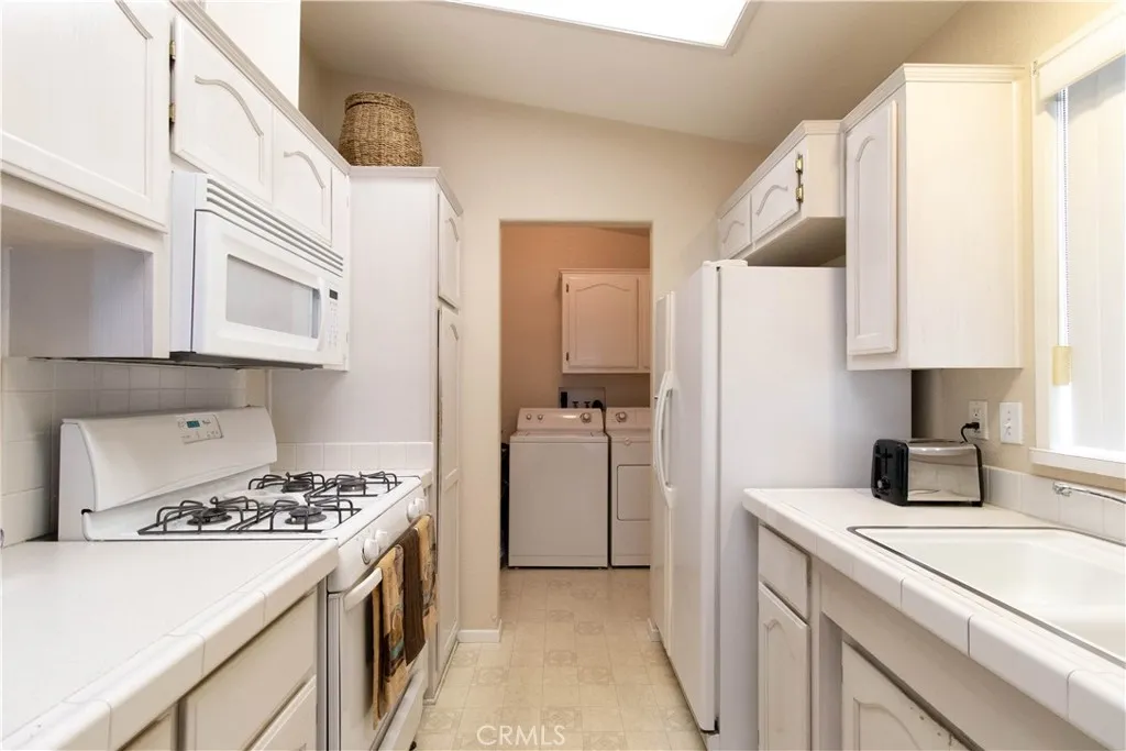 14352 Beach Westminster Ca, Unit 67 Westminster, CA 92683 - Photo 5 of 16 a kitchen with a stove and a refrigerator