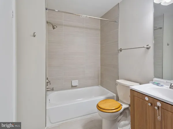 a bathroom with a granite countertop toilet a sink and a bathtub