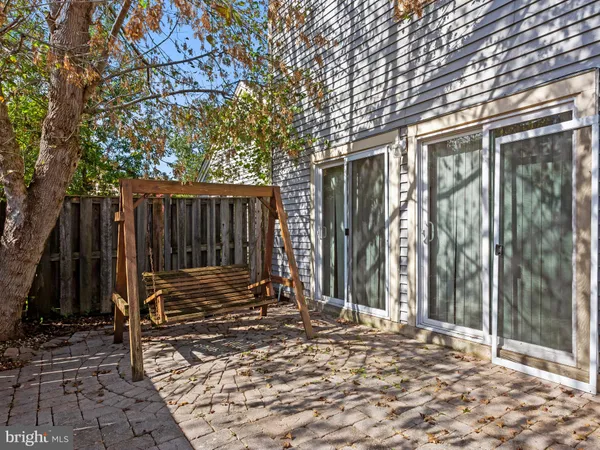 a view of backyard with wooden fence and a large tree