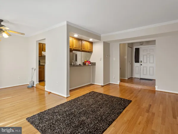 an empty room with wooden floor and closet