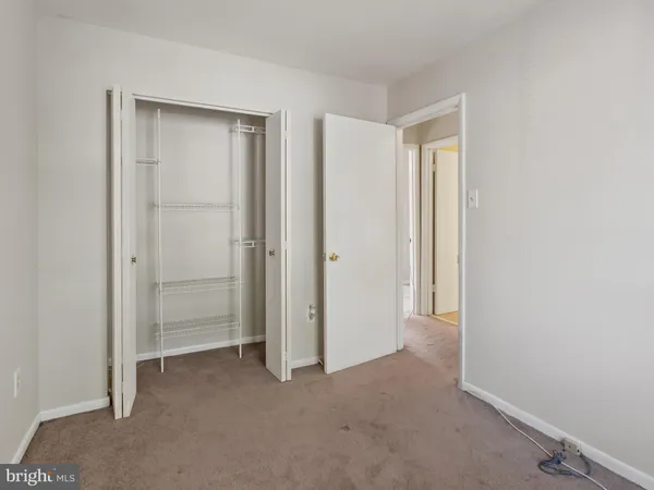a view of an empty room with closet area