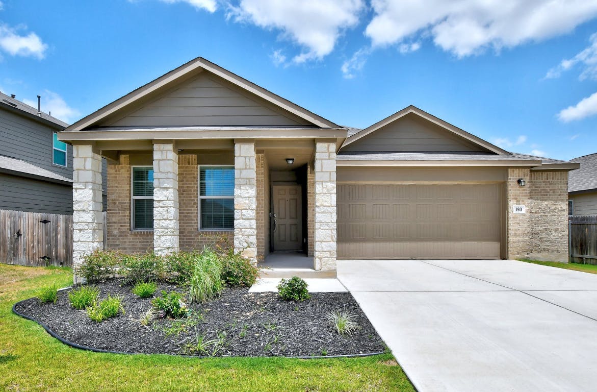 a front view of a house with garden