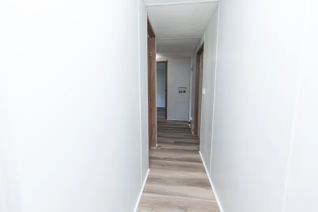 a view of a hallway with a white walls