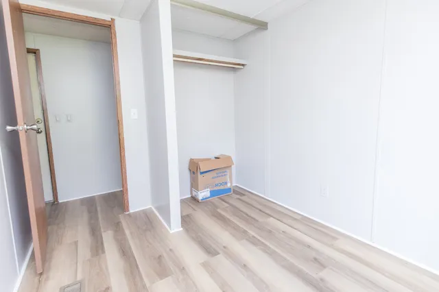 a view of a room with wooden floor