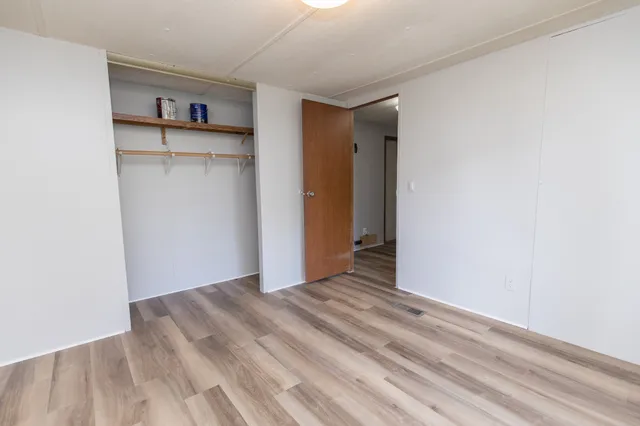 a view of a room with wooden floor
