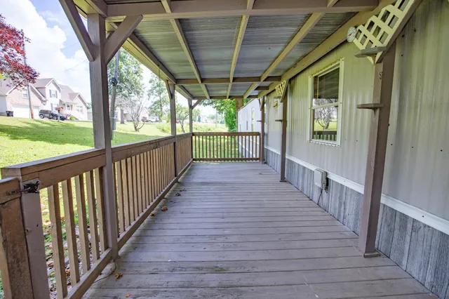 a view of a porch with wooden floor and outdoor space
