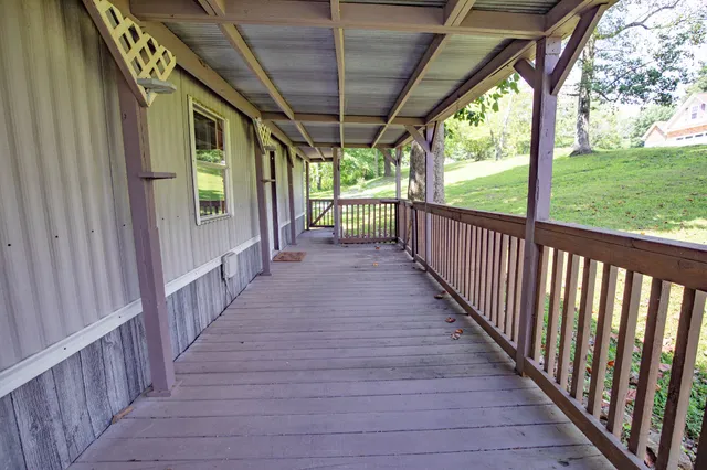 a view of a porch with wooden floor and stairs
