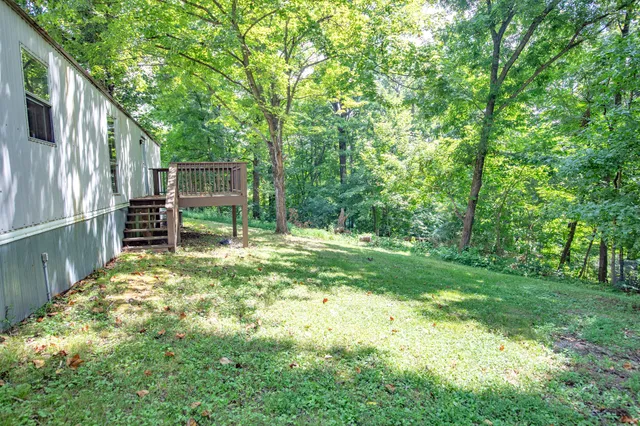 a backyard of a house with table and chairs