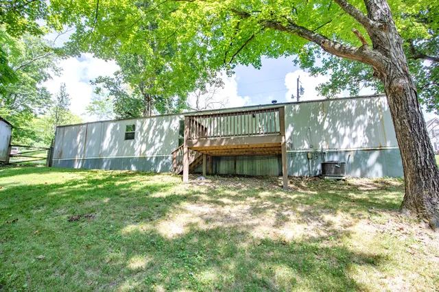 a view of house with backyard and a patio