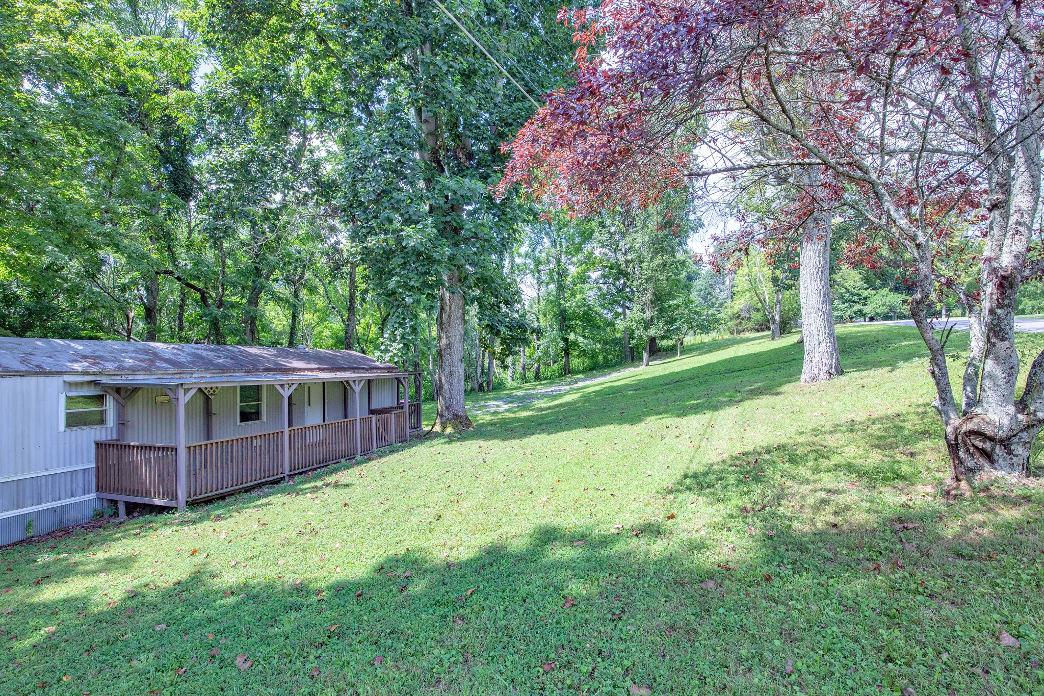 1304 Shell Road Goodlettsville, TN 37072 - Photo 35 of 40 a view of a house with a big yard and large trees